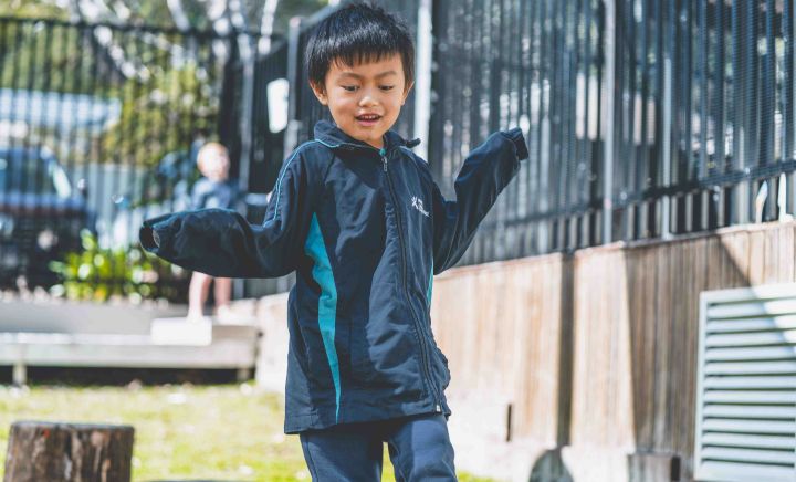 Student balancing and playing outdoors in school playground